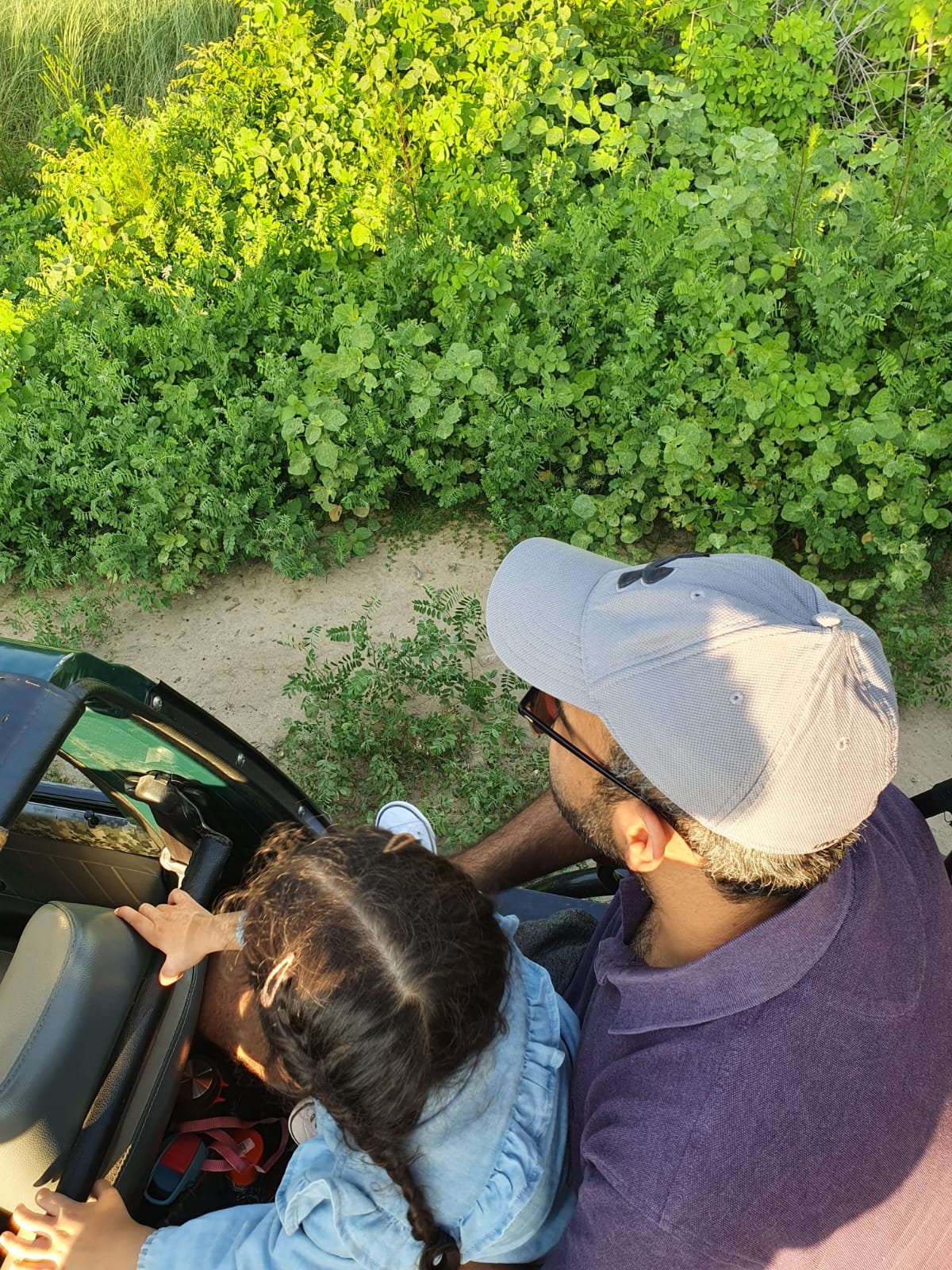 Father and daughter in safari jeep